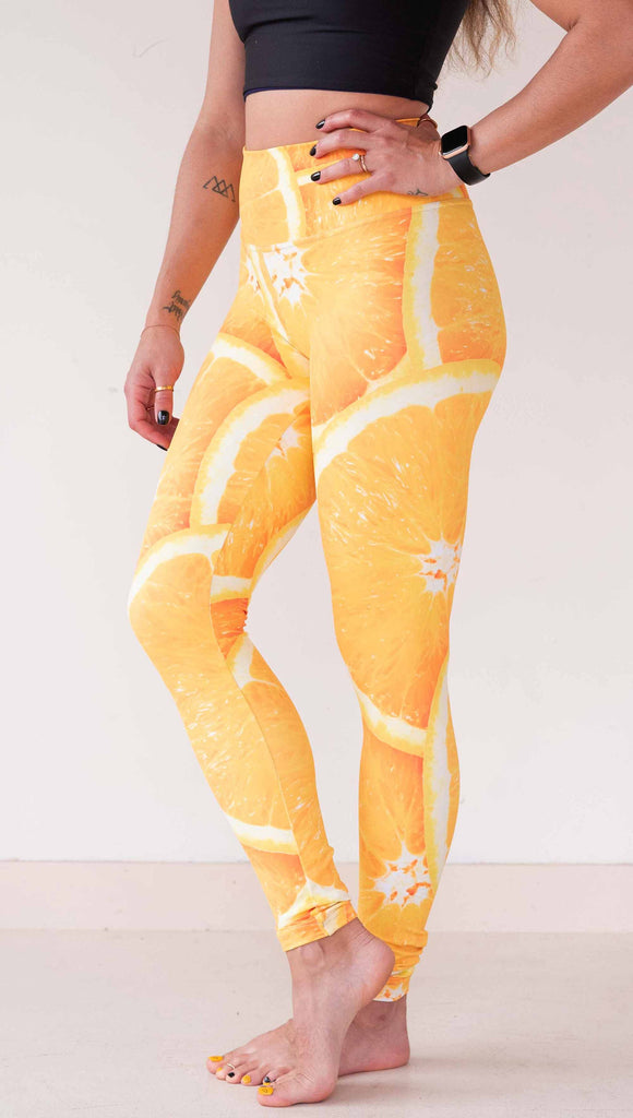 Model wearing WERKSHOP citrus leggings printed with a bright and bold macro image of meyer lemon slices.