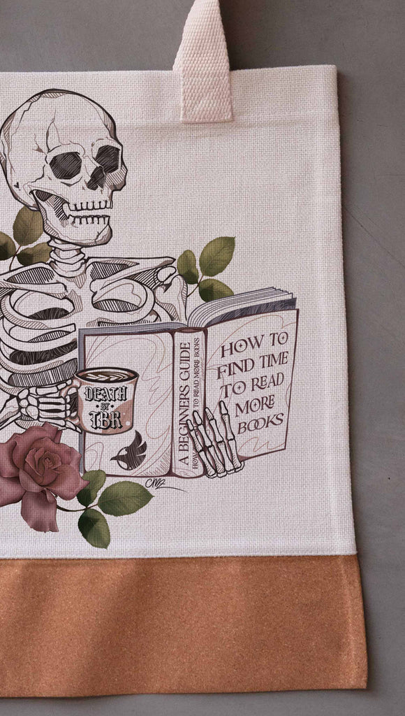 Zoomed in image of Death by TBR Tote Bag ~ Innocent/Clean version with the phrase, "How to Find Time to Read More Books". Featuring a skeleton holding a book in one hand and a coffee mug in the other with accent roses.