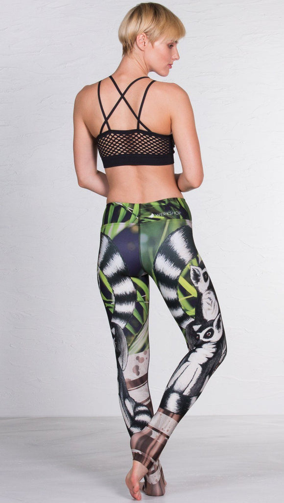 close up left side view of model wearing lemur themed printed full length leggings