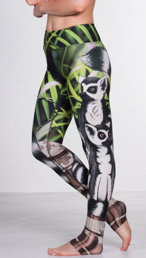 close up left side view of model wearing lemur themed printed full length leggings