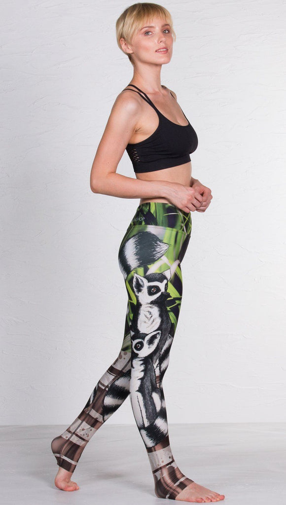 right side view of model wearing lemur themed printed full length leggings