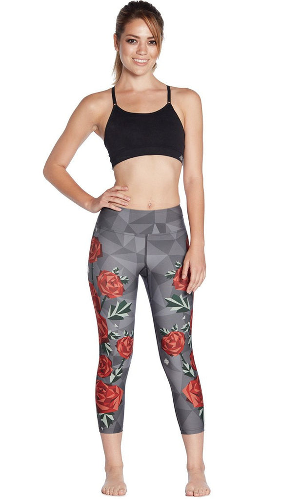 front view of model wearing geometric roses themed printed capri leggings